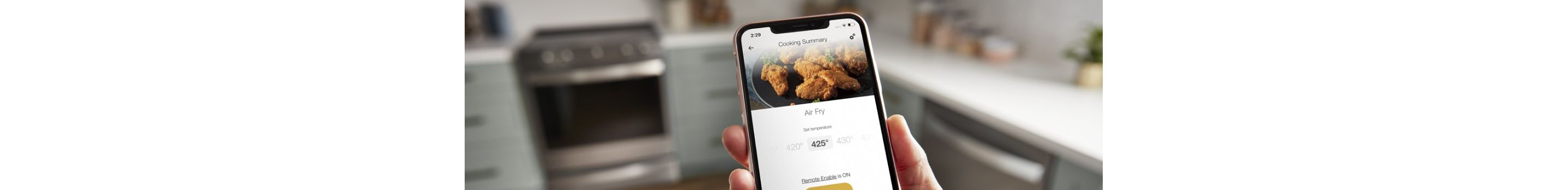 Hands using the Whirlpool® App to control their Whirlpool® Premium Electric Range