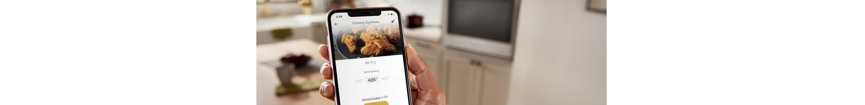 A hand using the Whirlpool® App on a smartphone.
