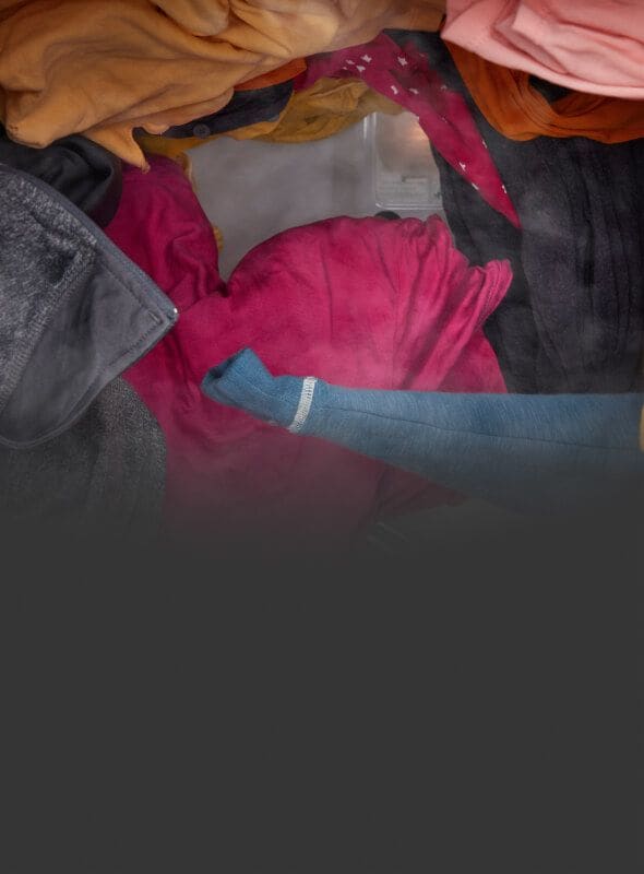 Clothes tumbling in a dryer with steam