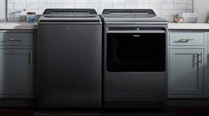 Whirlpool® Smart Capable Top Load Washer and Dryer in a laundry room