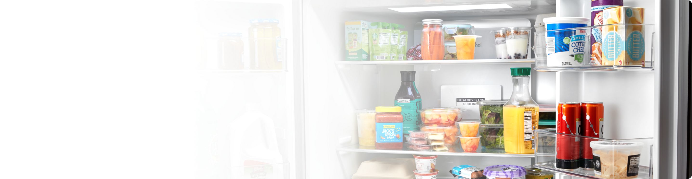 An open Whirlpool® 4 Door Refrigerator in a kitchen