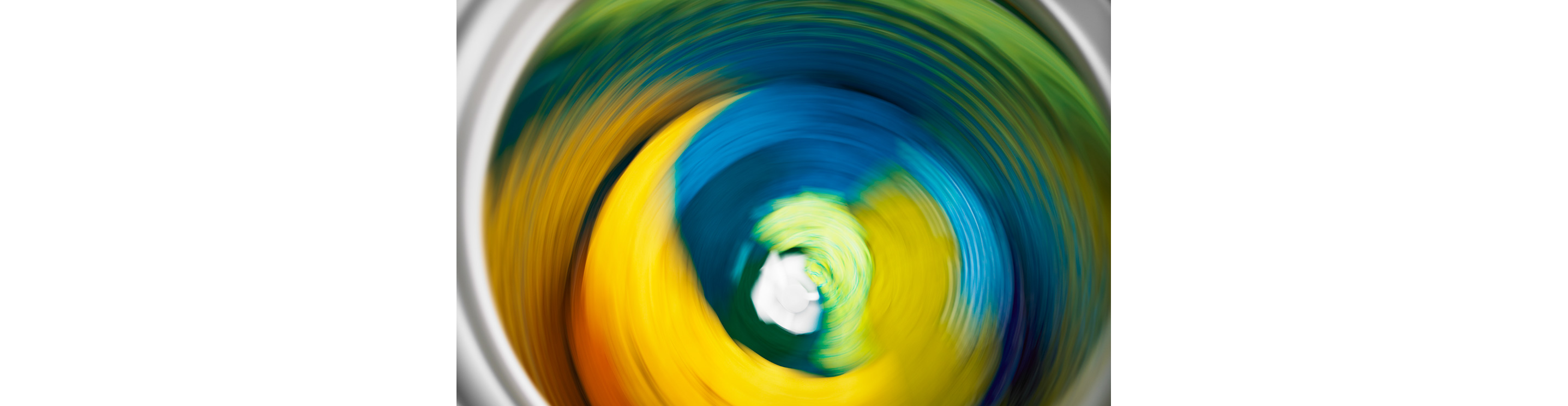  A load of colorful clothing going through a spin cycle.