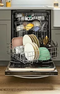 An open Whirlpool® Dishwasher with dishes inside