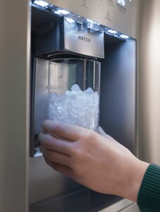 An external water and ice dispenser filling a glass with nugget ice