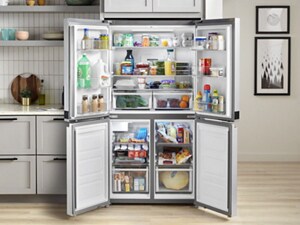 An open, 4-door fridge with food inside