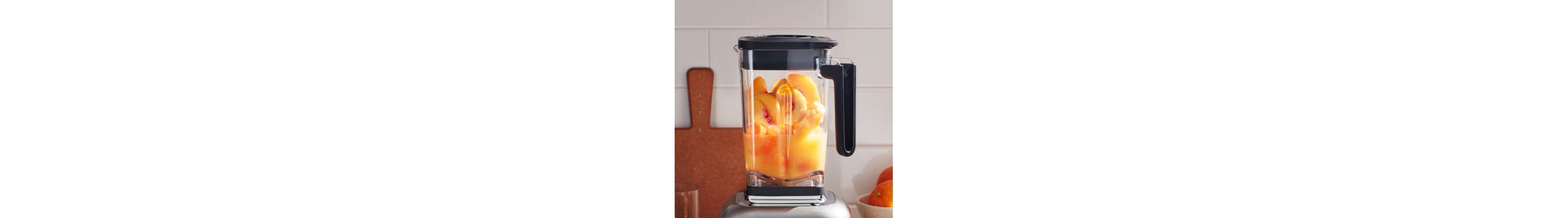 Halved peaches in a blender