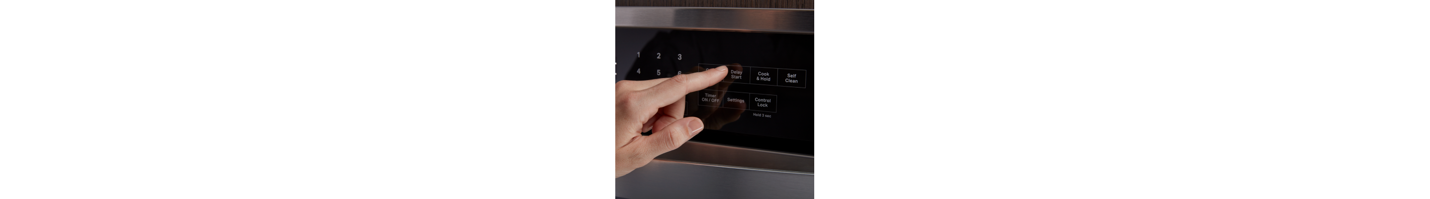  A person selecting the Delay Start option on an oven