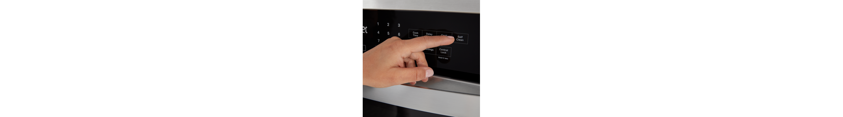 A person selecting the Self Clean option on an oven