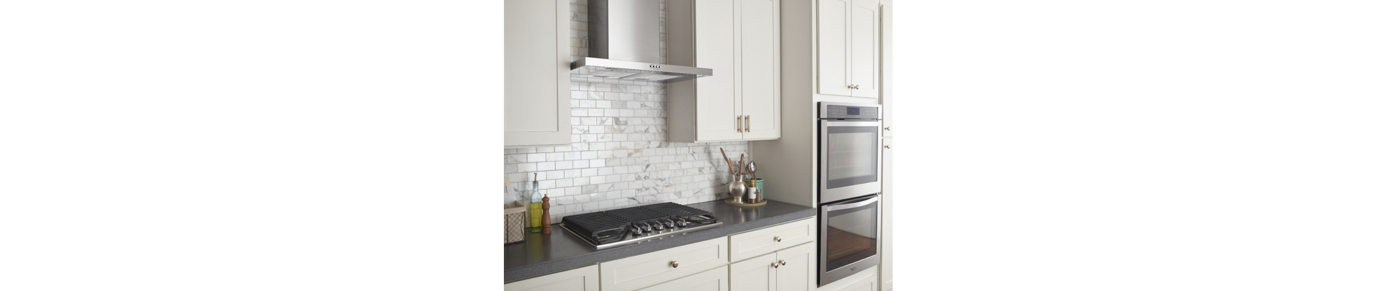 Stainless steel range hood over a cooktop