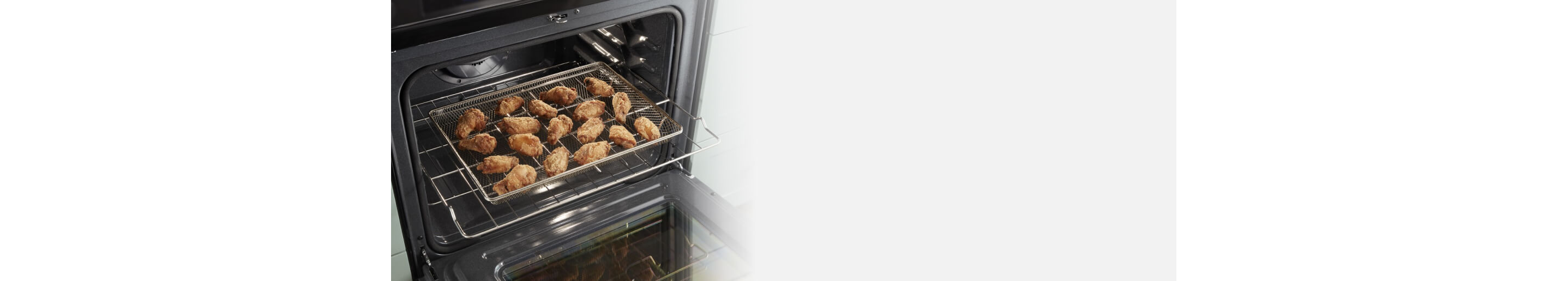 Chicken wings in an air fry basket in an oven
