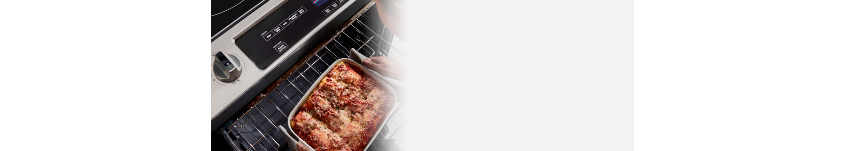 Person removing a casserole dish from an oven