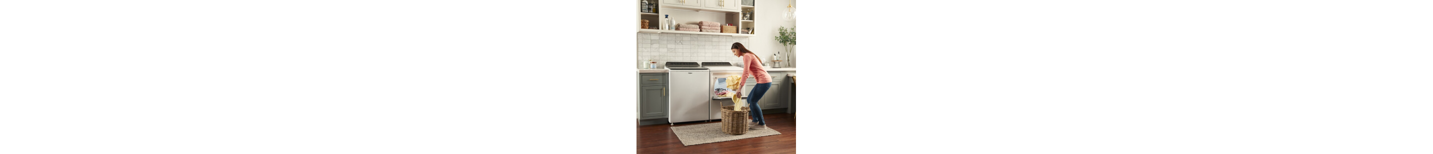 Person loading laundry into a top load dryer