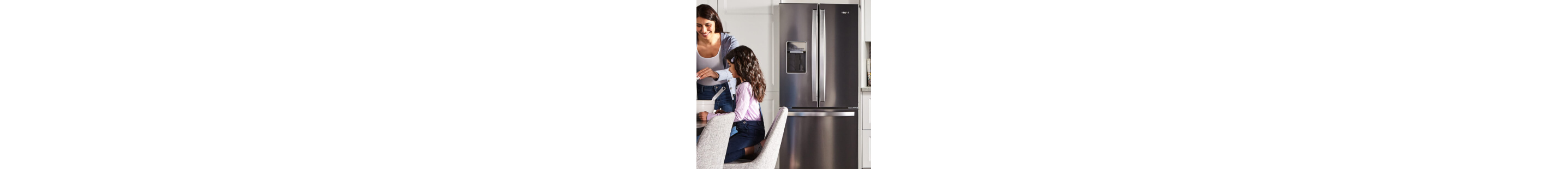 Person and child standing in front of a stainless steel refrigerator