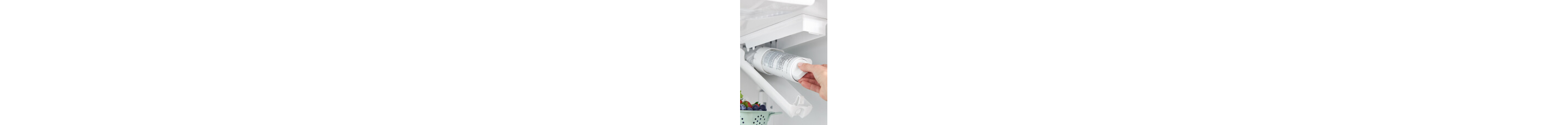 Person placing a water filter inside a refrigerator