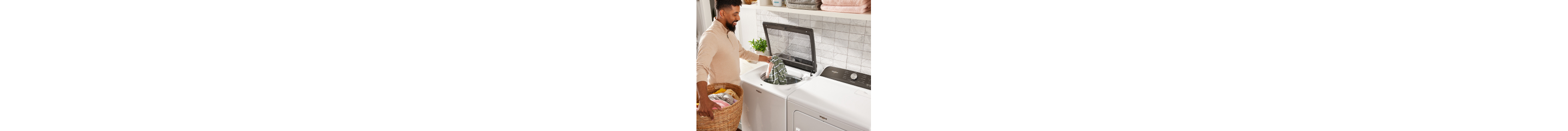 Person loading laundry in a top load washer