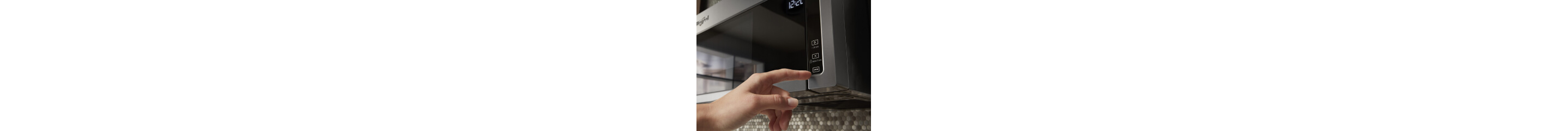 Person selecting a microwave setting on a control panel