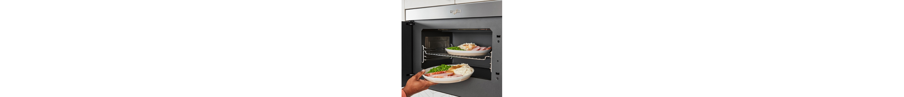 A person reheating leftovers in a microwave