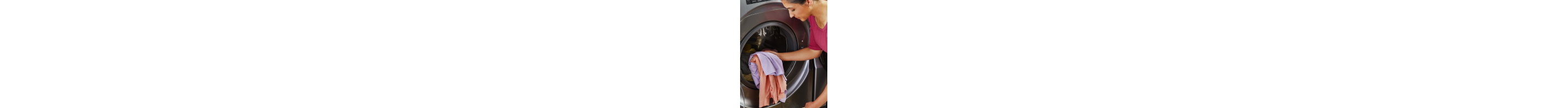 Person loading laundry into a front load washing machine