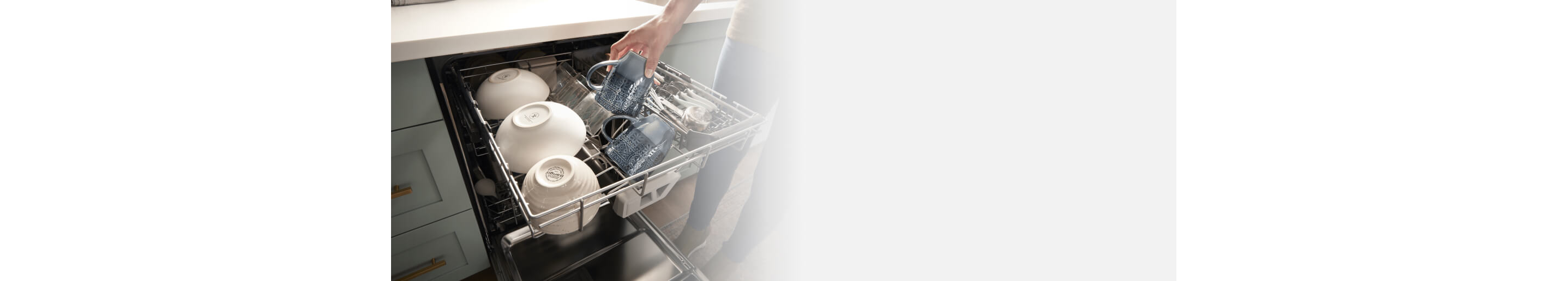 Dishes being placed inside a Whirlpool® Dishwasher with 3rd Rack