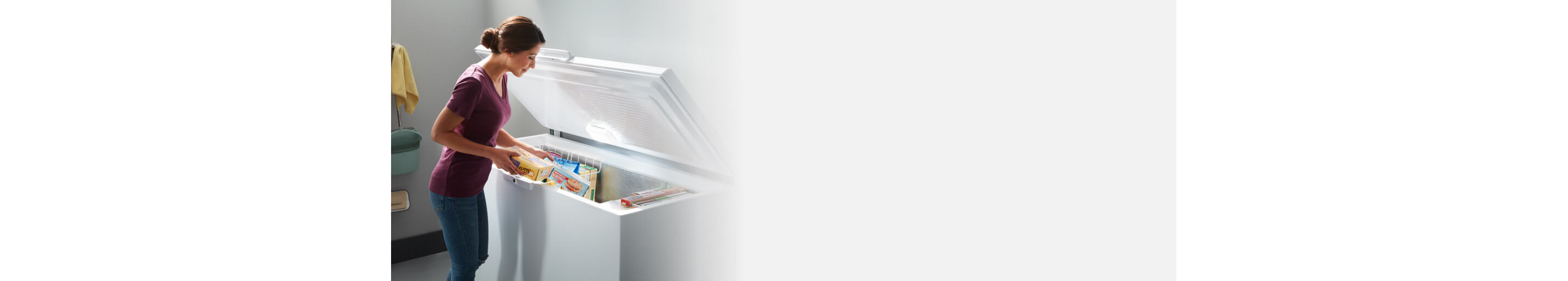 Person loading food into a chest freezer