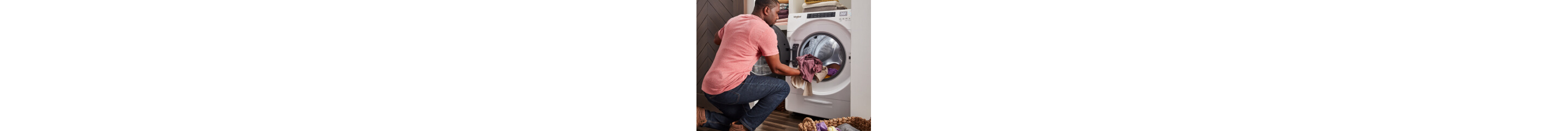 Person loading laundry in a front load dryer