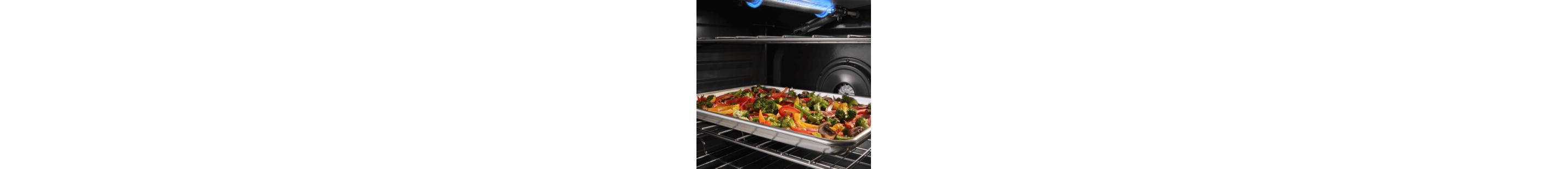 Sheet pan filled with vegetables inside an oven