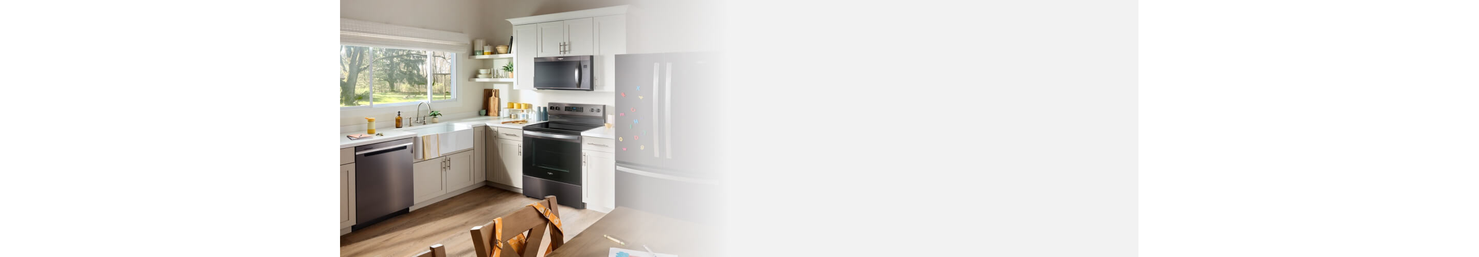 Whirlpool® appliances in a kitchen with white cabinets