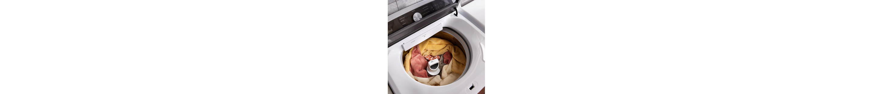 Orange and yellow clothes in a top load washer