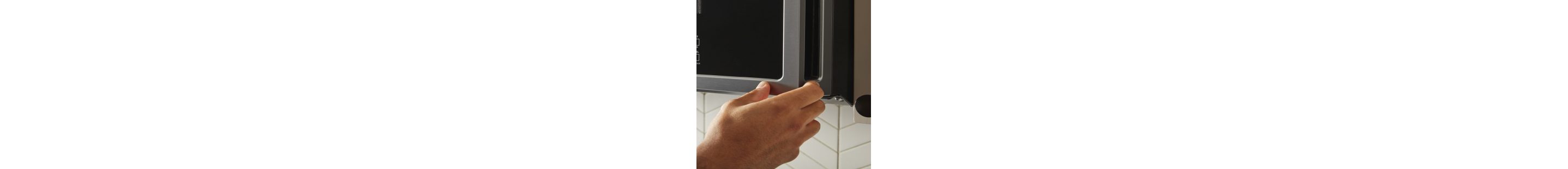 A hand opening a microwave door