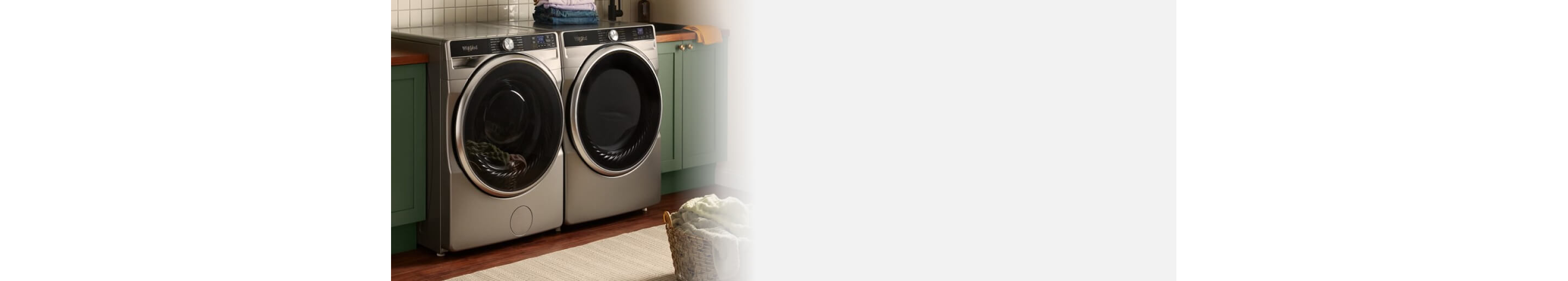 Front load washer and dryer set in a laundry room