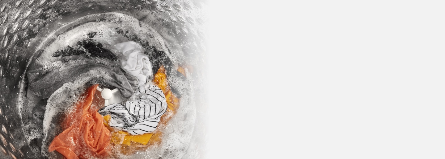 Laundry being washed in a top load washing machine with impeller