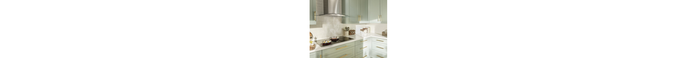 A Stainless Steel range hood collecting steam from a cooktop