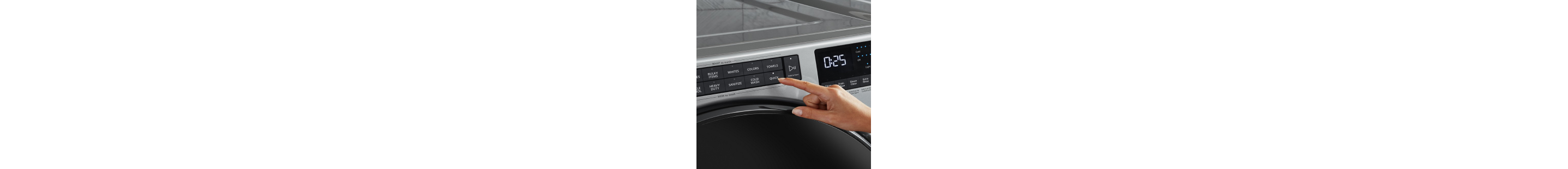 A person selecting a wash cycle on a washing machine