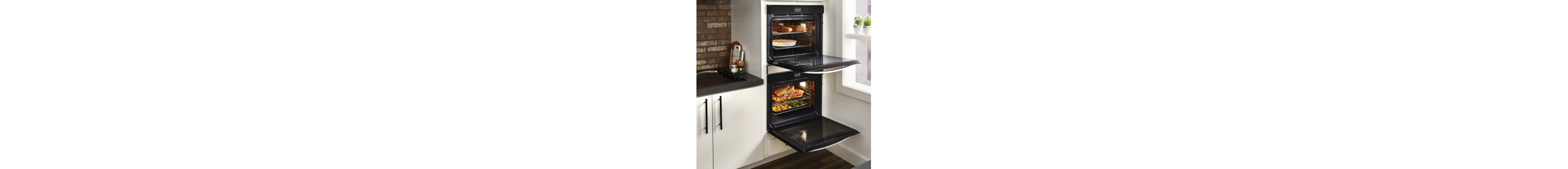 An opened double wall oven with food cooking inside