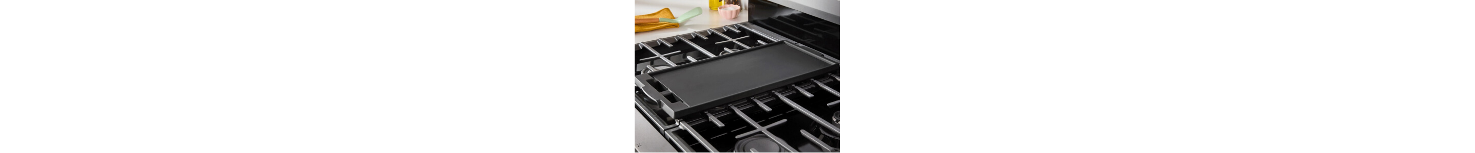 A griddle pan shown inset onto an otherwise empty stovetop on a range