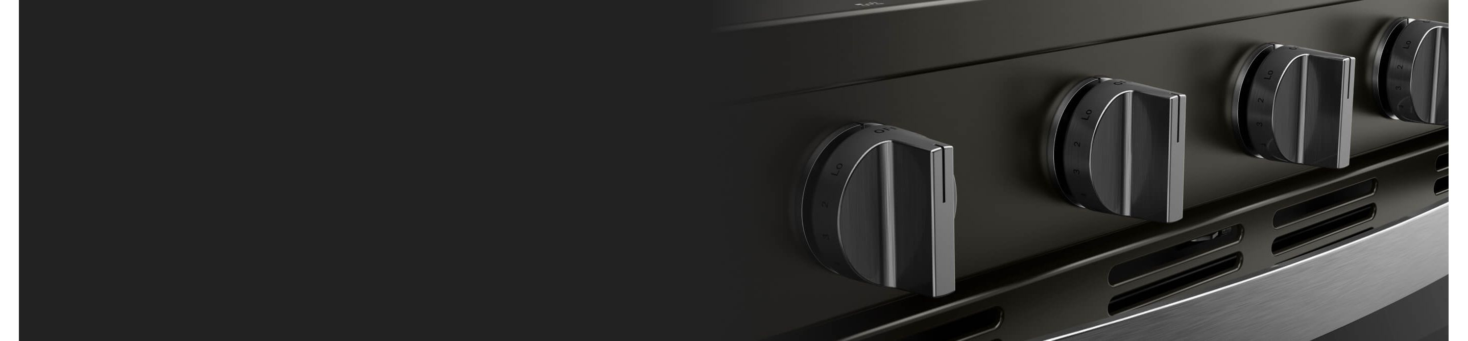 Closeup of the dials on the front of an oven
