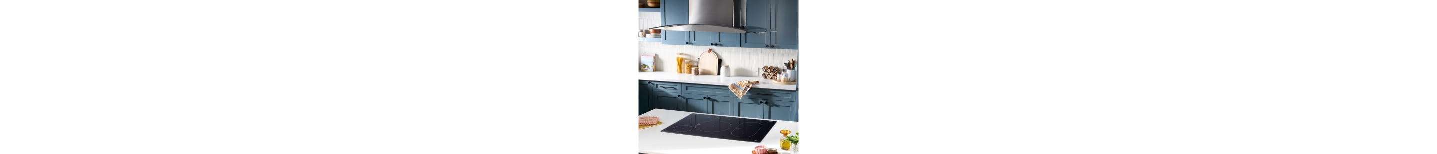 A Whirlpool® Induction Cooktop in a kitchen with blue cabinets