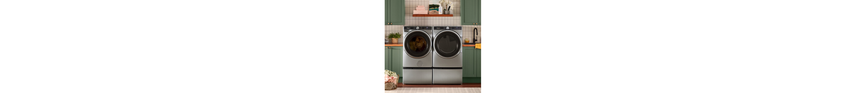 A Whirlpool® Washer and Dryer set with green cabinetry