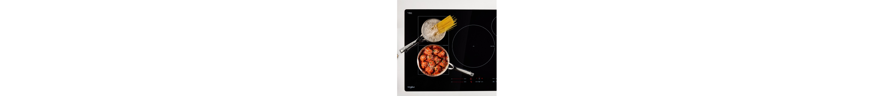 Pasta noodles boiling and meatballs simmering on a cooktop