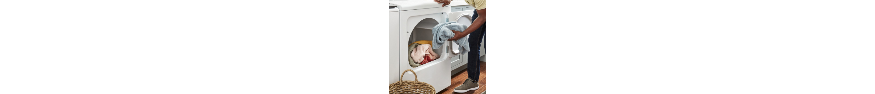 A person taking clothes out of a dryer