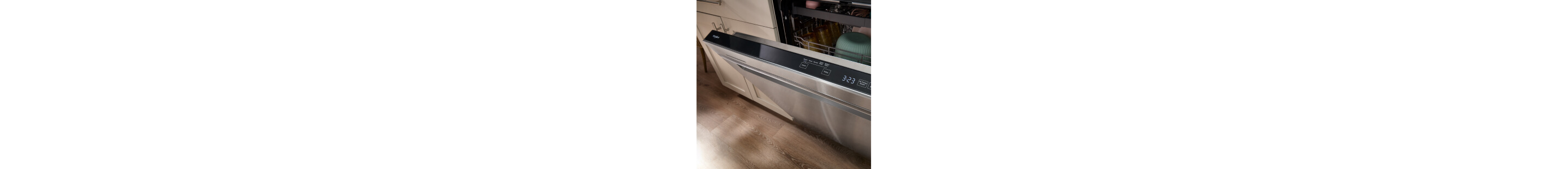 An open stainless steel Whirlpool® Dishwasher with dishes inside