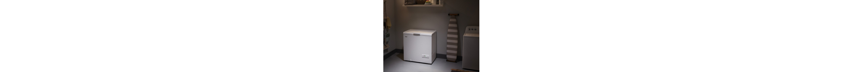 A white chest freezer in a garage