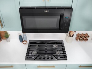 A Whirlpool® Microwave above a Whirlpool® Cooktop