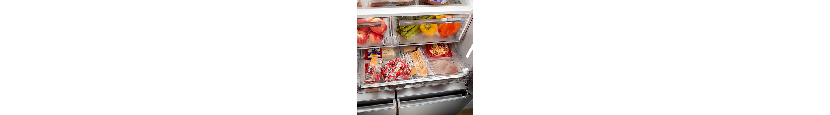 Pull-out drawer stocked with small snack items below humidity crispers