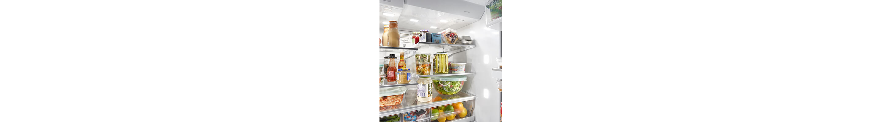 Fresh food and condiments stocked in refrigerator compartment