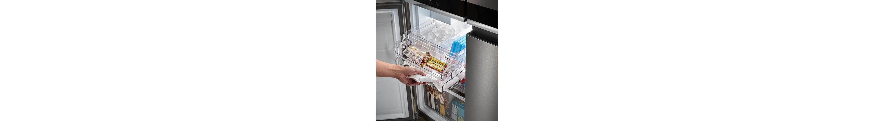 Person sliding ice drawer out of bottom-left 4-door compartment