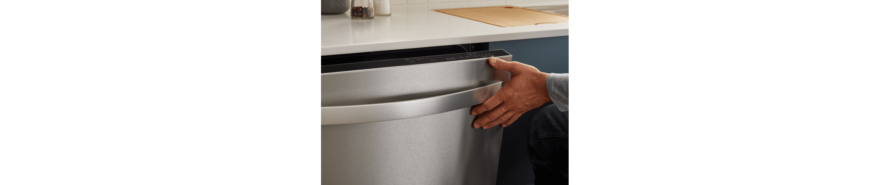 Person closing a top control dishwasher