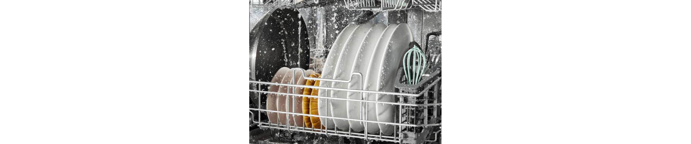 Dishes being rinsed in a dishwasher