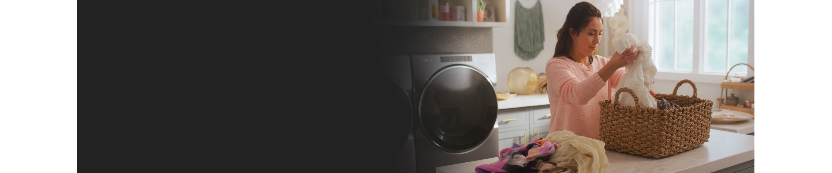 Woman picking up clothes from a laundry basket