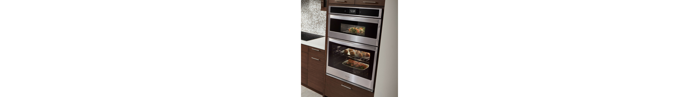 Whirlpool® stainless steel combination wall oven set into wood finished cabinets. 